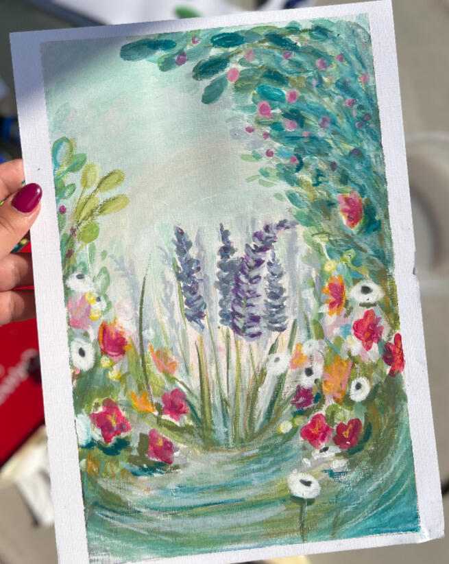 starry hand holding a painting on paper, representing a impressionistic / semi abstract botanical nature inspired scene with lavender, leaves and wildflowers