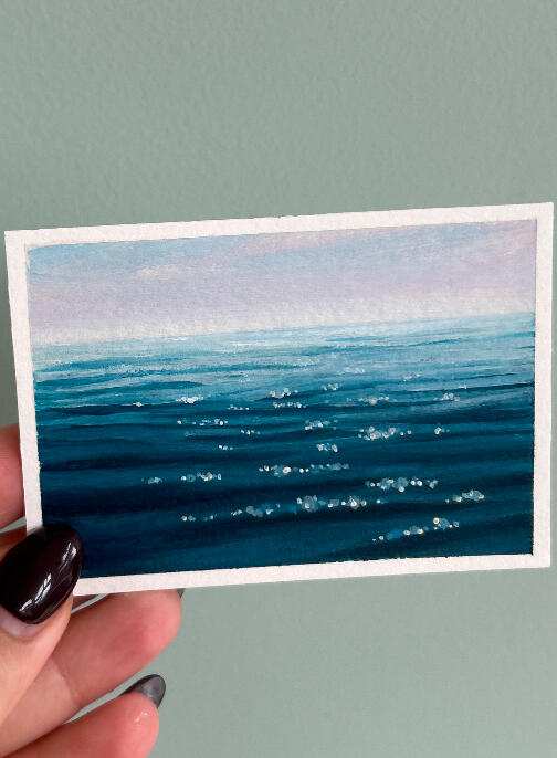 sold seascape aceo sold seascape aceo painting on paper, showing a blue ocean surface view and hazy horizon. painting is showed held by hand